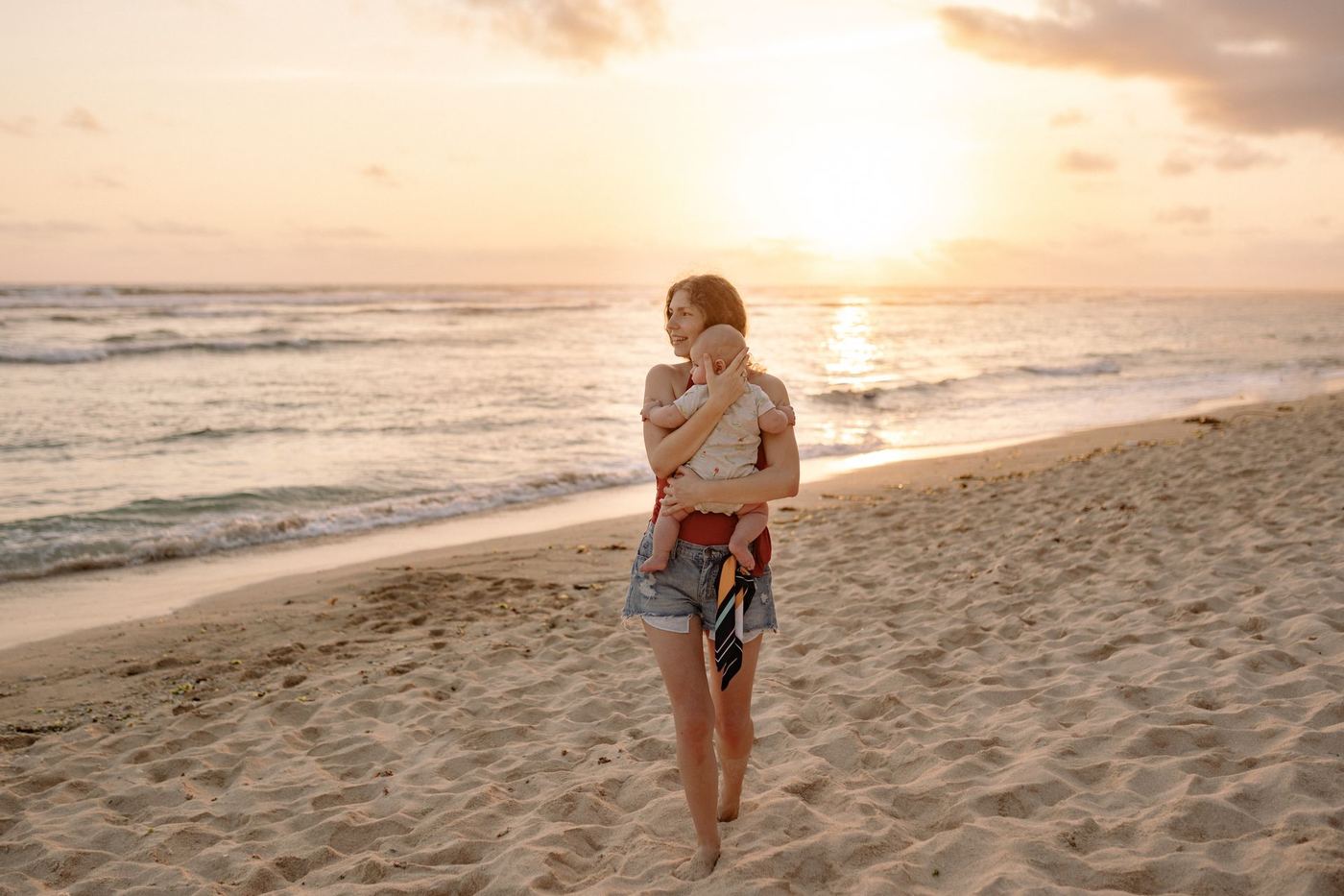 A family enjoying a golden sunset on the beach in Santa Teresa, Guanacaste, Costa Rica