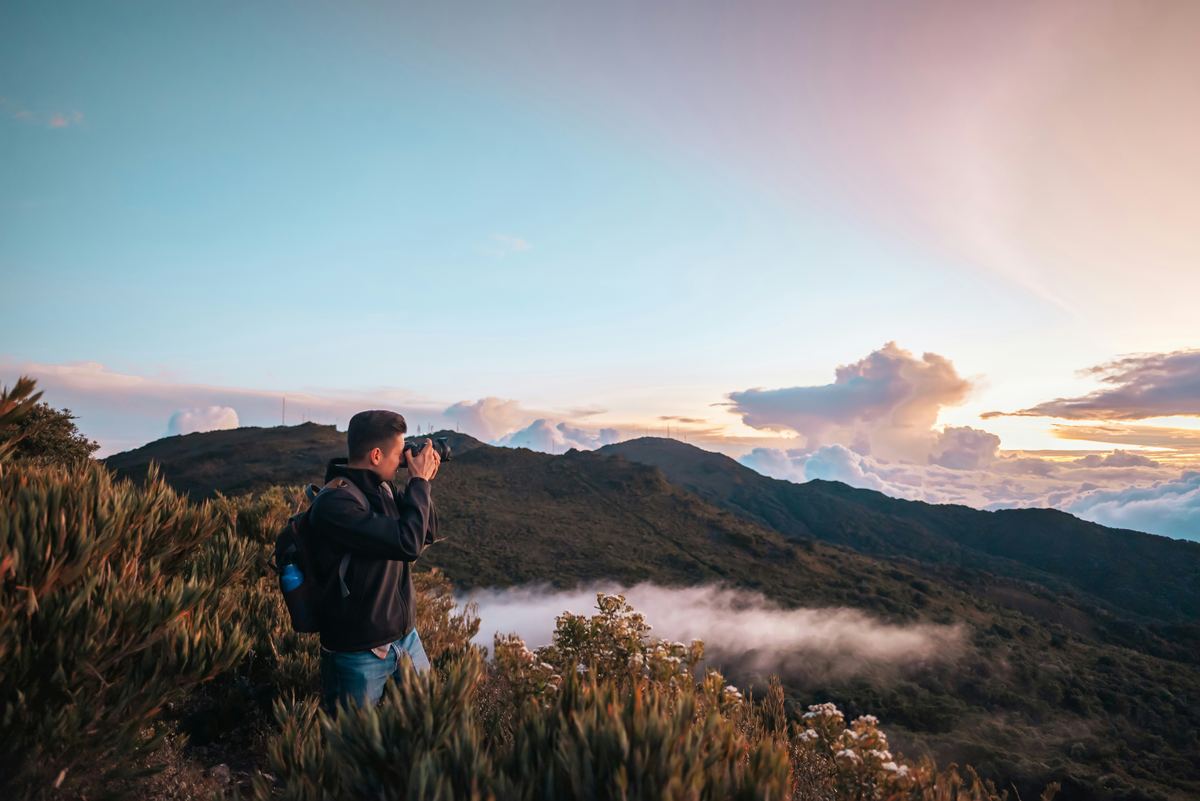 Traveler photographing misty mountain views on a Costa Rica scouting trip